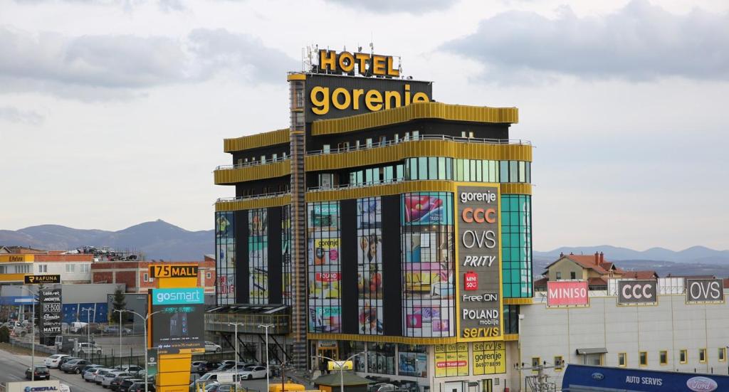 a large building with a sign on top of it at Hotel Gorenje in Pristina