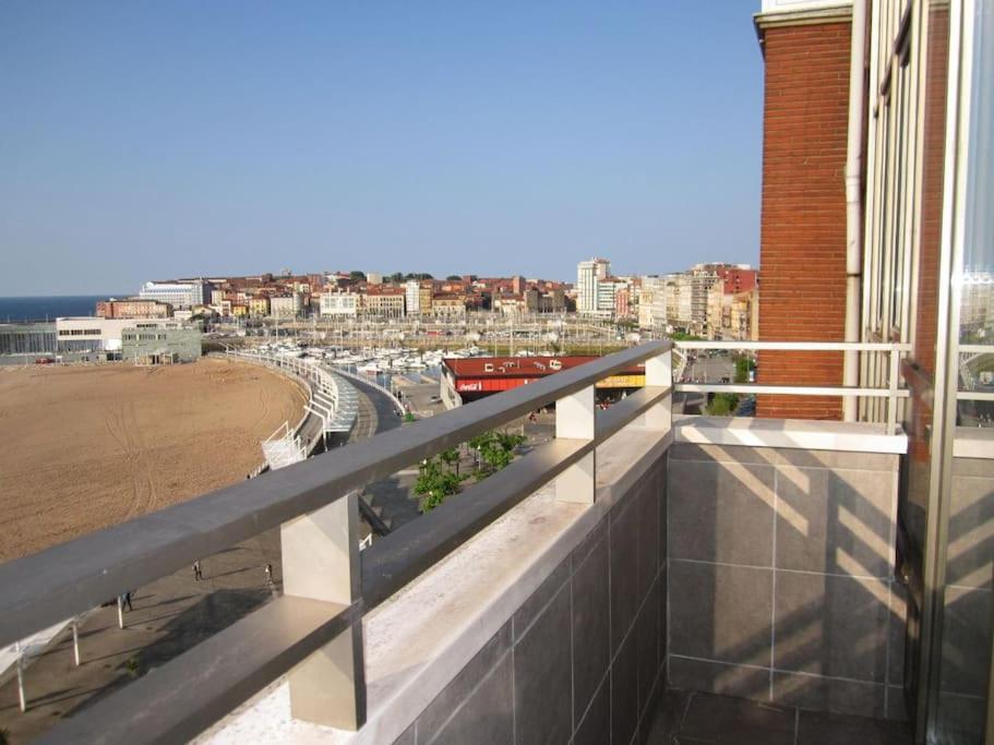 uma varanda de um edifício com vista para a praia em Sunshine beach Gijón em Gijón