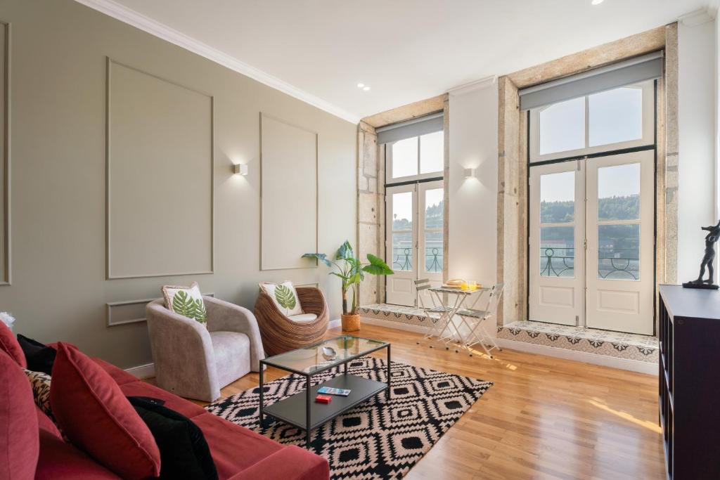 a living room with a couch and a table at Apartamento Premium Douro River Views in Porto