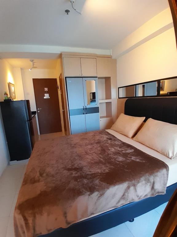 a bedroom with a large bed in a room at Pleasant6tifolia in Jakarta