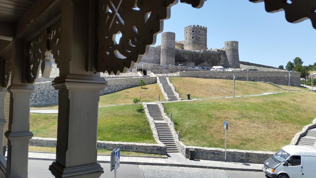 a van parked in front of a castle at Hotel New Star in Akhaltsikhe