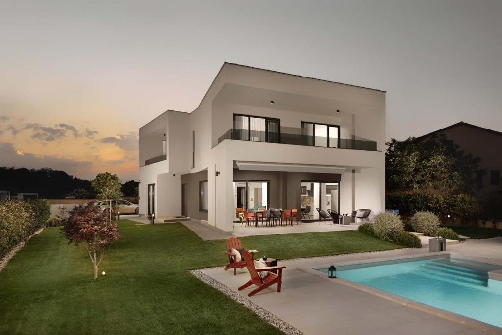 a large white house with a pool in front of it at Villa Zen in Vintijan