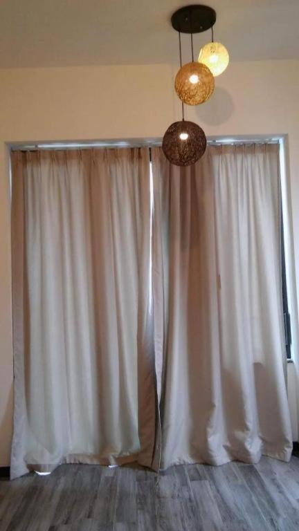 a room with a white curtain and two lights at One in Grimsby