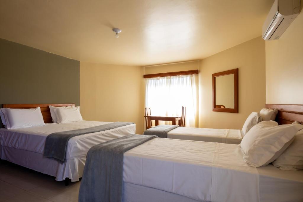 Postel nebo postele na pokoji v ubytování Canzi Cataratas Hotel