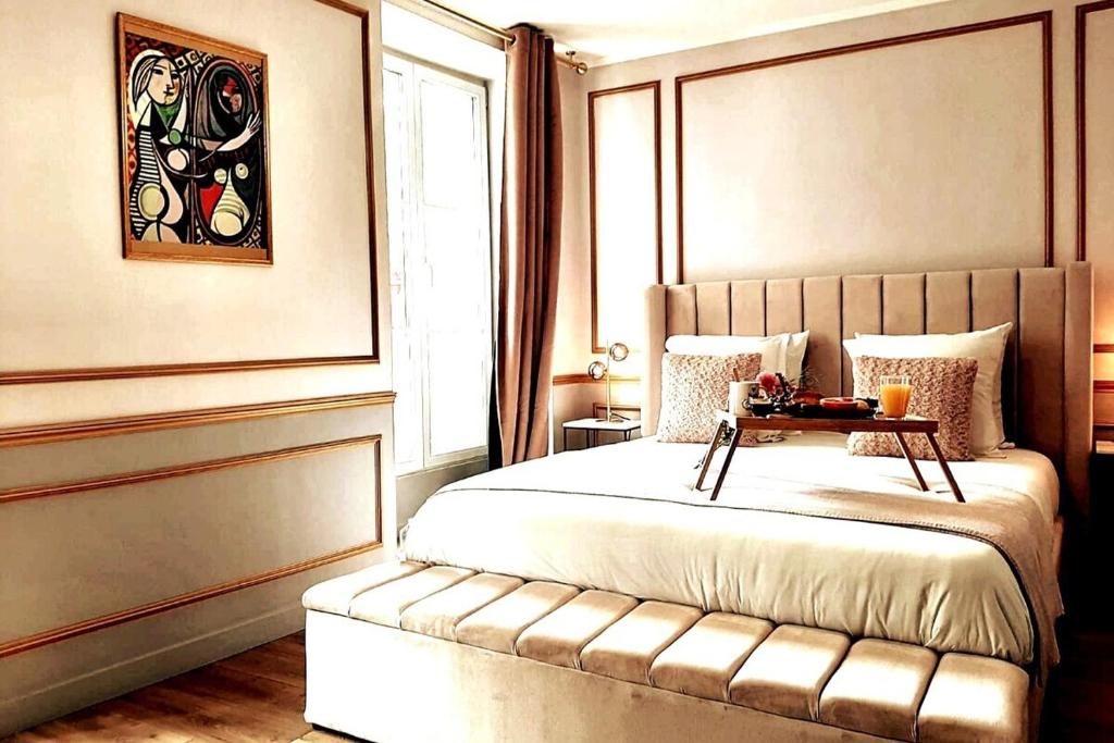 Un dormitorio con una cama con una mesa. en Da Vinci Apartment Paris Montmartre AirCon, en París