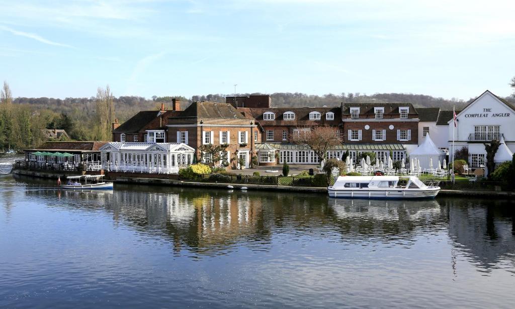 a group of buildings and boats on a river at Macdonald Compleat Angler in Marlow