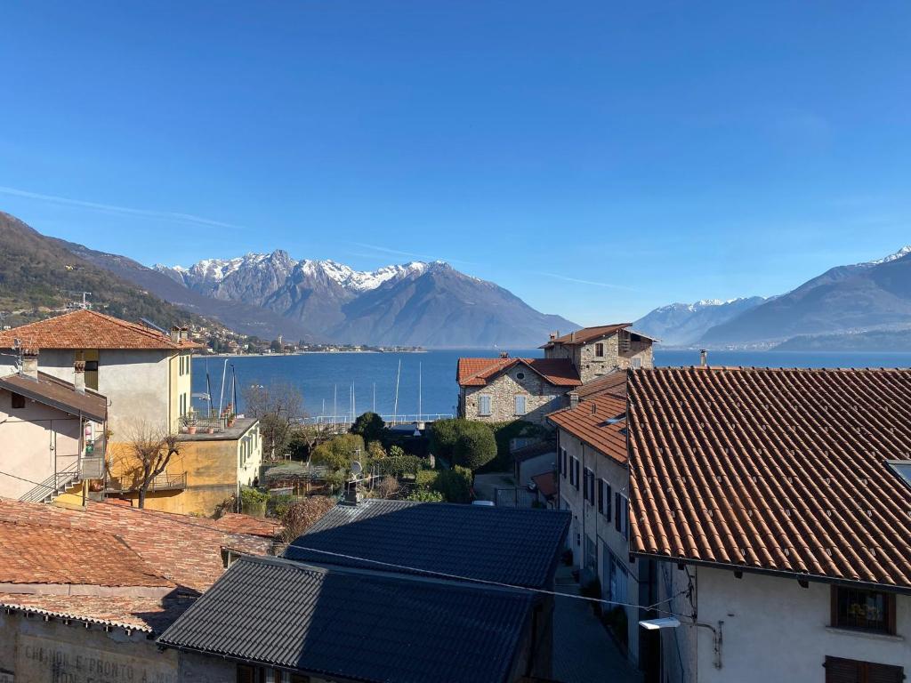 a view of a town with mountains and a body of water at Lakeside Apartment in Gravedona