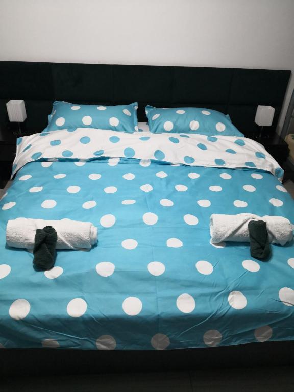 a bed with polka dot sheets and towels on it at Dalival in Baile Felix