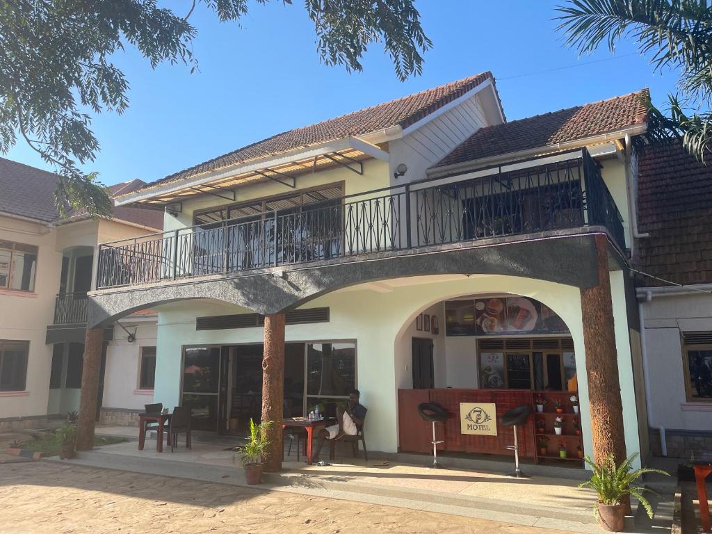 a building with a balcony on top of it at 7 Days Hotel in Entebbe