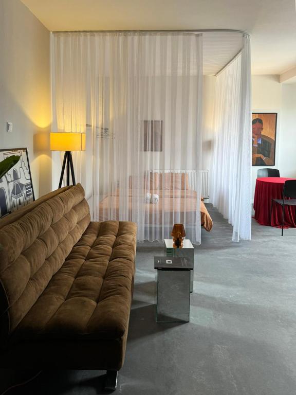 a living room with a couch and a table at Etern Stays - PRN Apartment in Pristina