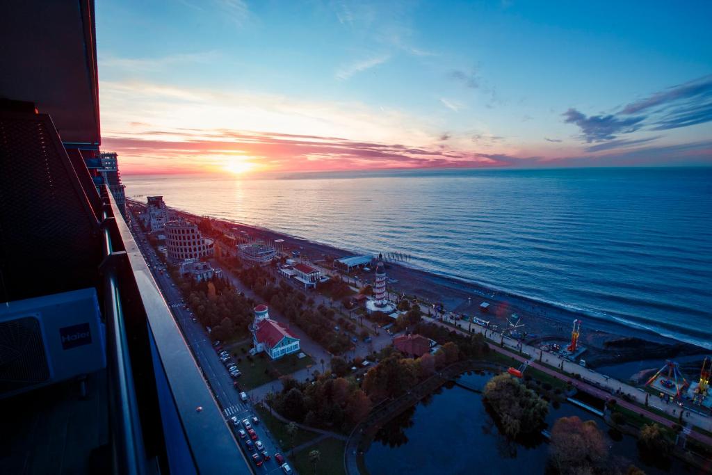 an aerial view of a beach at sunset at Panorama Sea View Orbi City Aparthotel Batumi Beach in Batumi