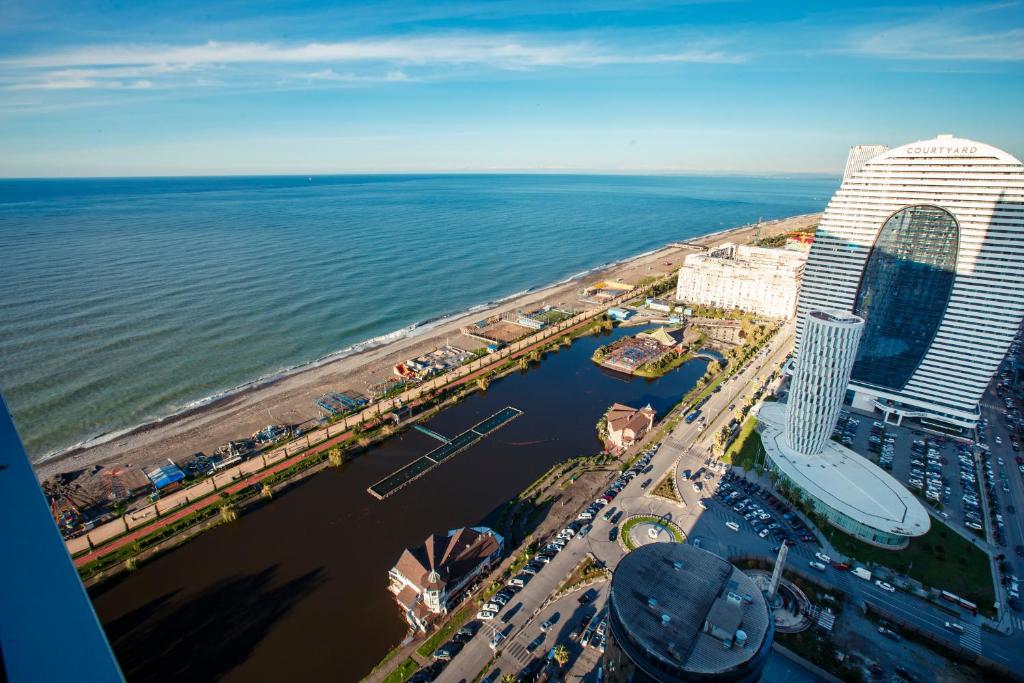 an aerial view of a beach and a large building at Panorama Sea View Orbi City Aparthotel Batumi Beach in Batumi