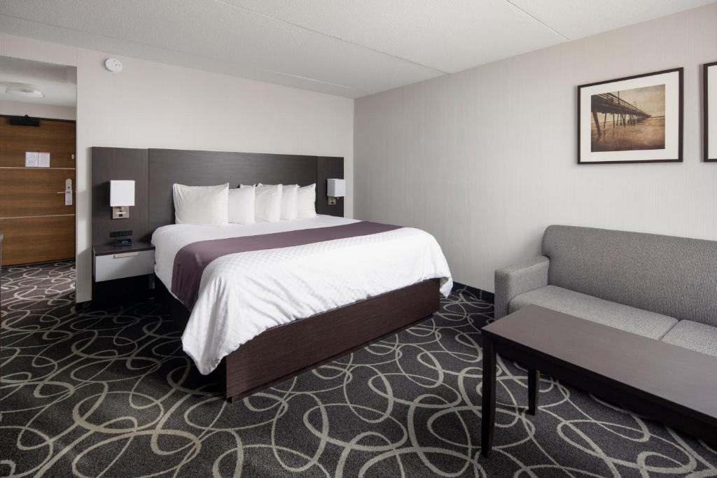 a hotel room with a bed and a couch at Stonecroft Inn in Windsor