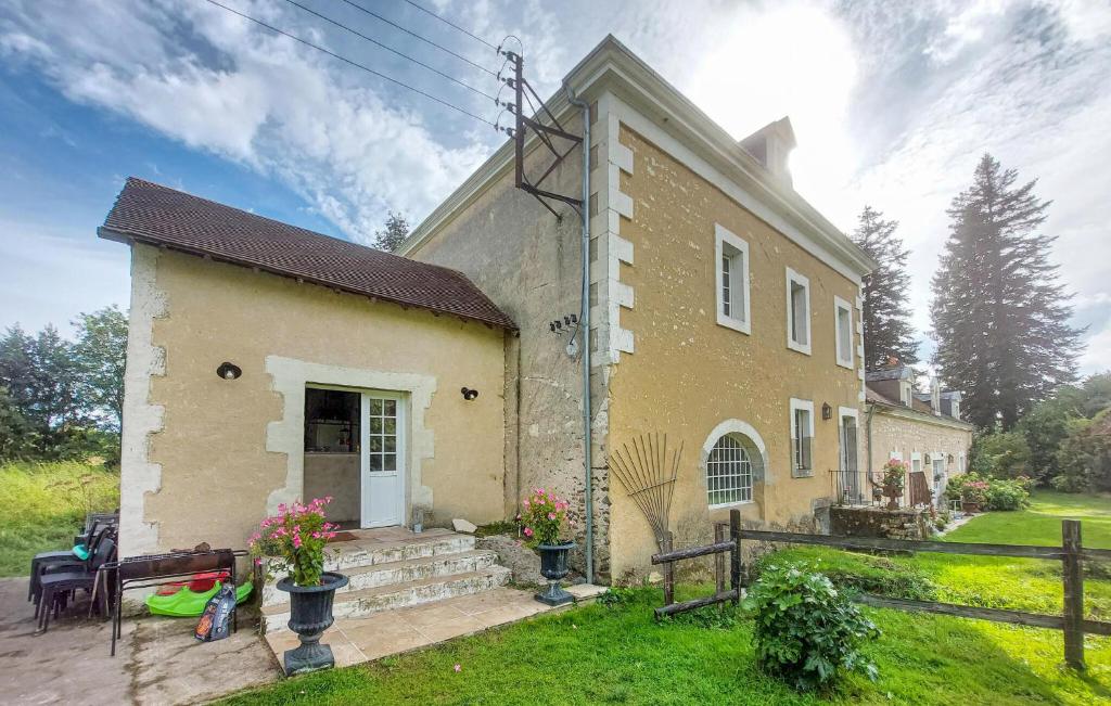 a small yellow house with a fence and a yard at Gorgeous Home In commoy With Heated Swimming Pool in Écommoy