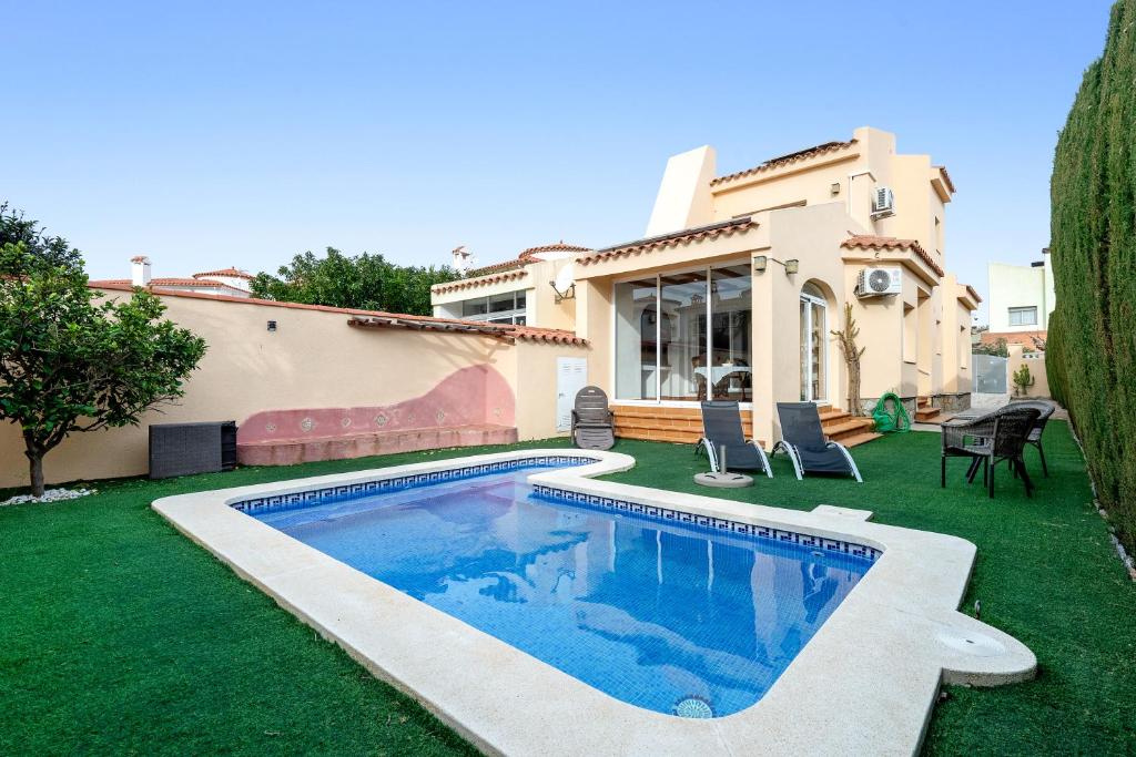 a swimming pool in the yard of a house at Can Lucia in Miami Platja