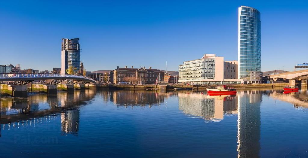 a view of a river with buildings and a bridge at The Obel in Belfast