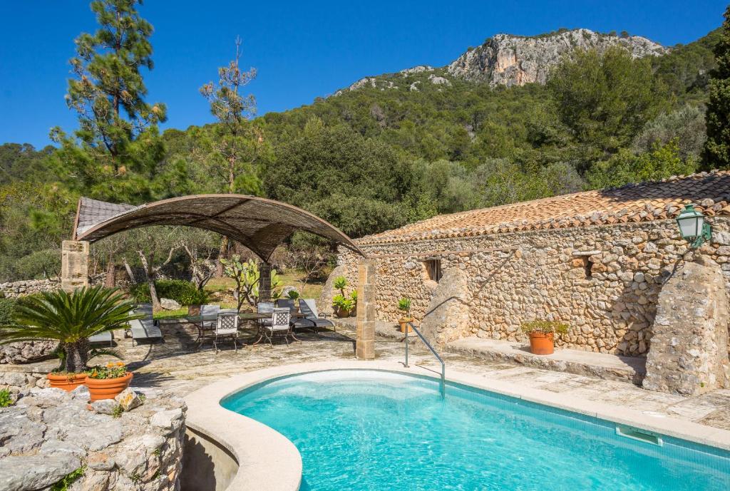 a house with a swimming pool in a yard at Finca Es Castell in Binibona
