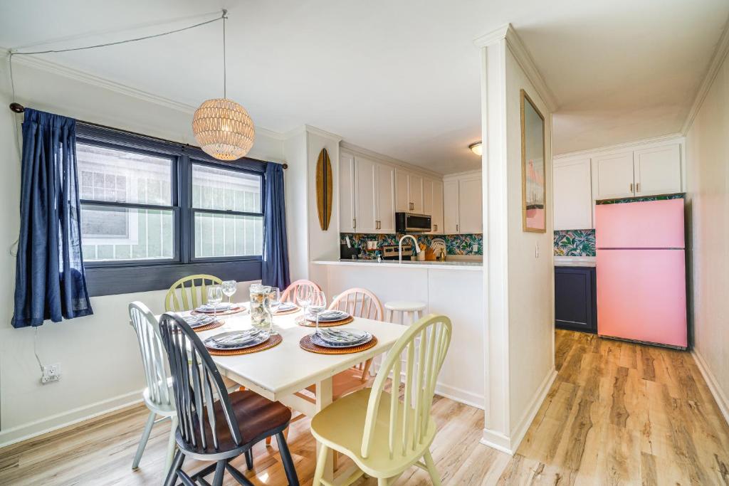 a kitchen and dining room with a table and chairs at Kill Devil Hills Condo with Beach Access On-Site! in Kill Devil Hills
