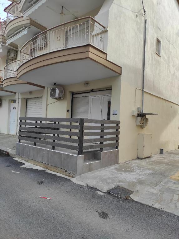 a building with a balcony on the side of it at Nikos house studios in Ofrínion