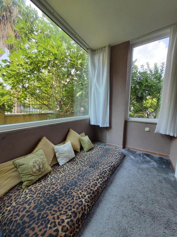 a room with a large bed with pillows and a window at A COZY HOME for A LARGE FAMİLY in Marmaris