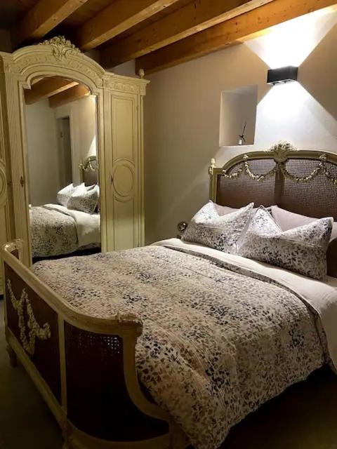a bedroom with a bed and a large mirror at Ca'Gialla in Bellinzona