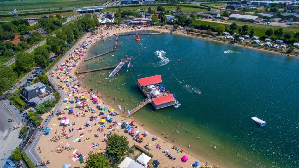 an aerial view of a beach with a crowd of people at Glamping Betuwestrand in Beesd