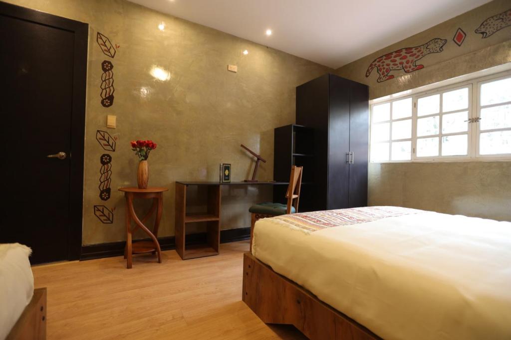 Postel nebo postele na pokoji v ubytování Chakana Hotel Boutique Mariscal