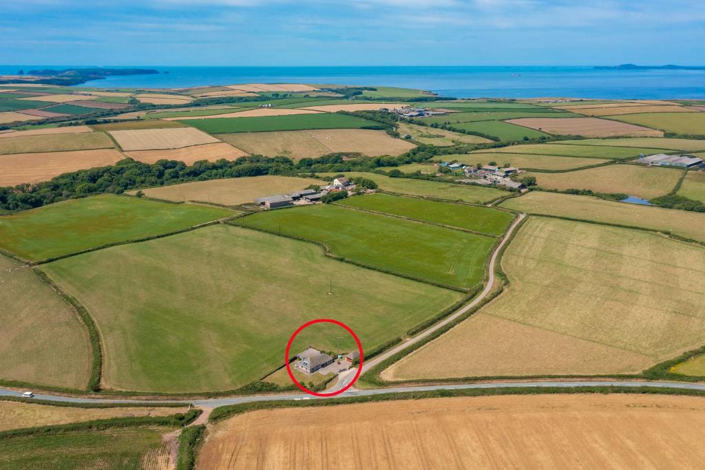 a red circle in the middle of a field at Coastal Bungalow Near Marloes with Log Burner and Garden in Dale