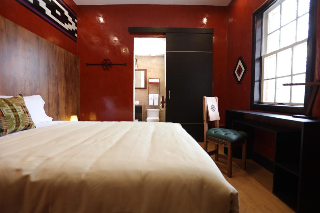 Postel nebo postele na pokoji v ubytování Chakana Hotel Boutique Mariscal