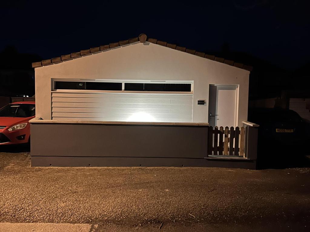 a garage with a large white garage door at night at Lovely 1-Bed Apartment in Glastonbury in Glastonbury