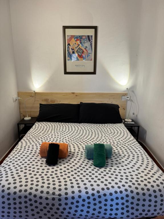 a bedroom with a bed with two pillows on it at Louie Louie Apartment Old Town in Tarragona