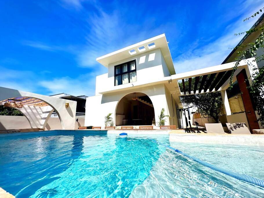 a house with a swimming pool in front of a house at VillaMaya- Hidden City Oasis in Mayaguez