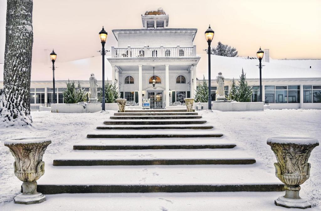 a white building with snow on the steps at Four Seasons Island Resort in Pembine