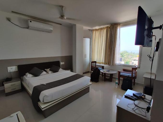 a bedroom with a large bed and a television in it at Hermit crab 19 in Ullāl