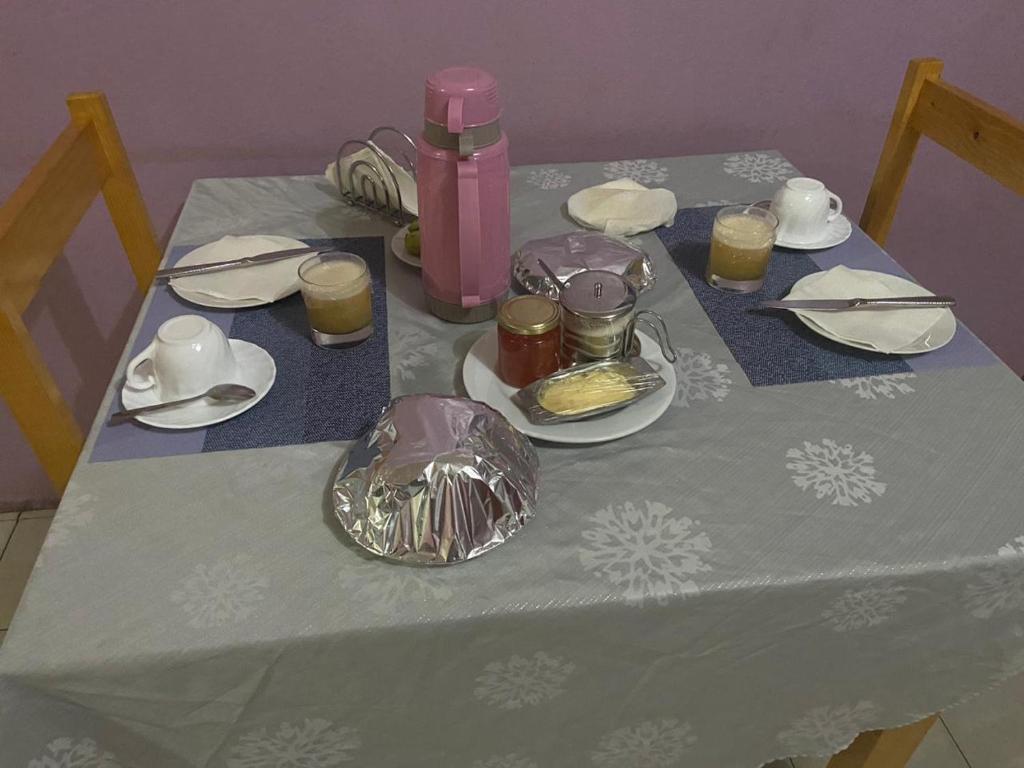 a table with a blue table cloth with food on it at Casa Ze & sonia in Portela