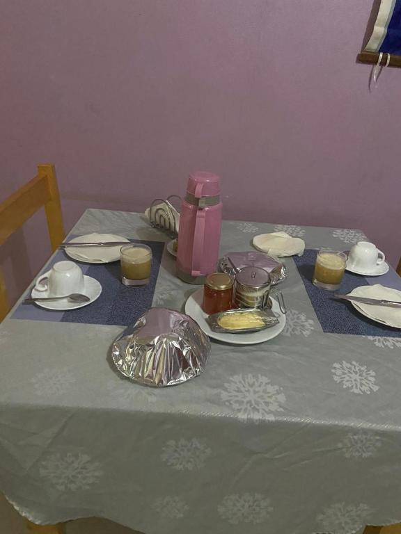 a table with a blue table cloth with food and candles at Casa Ze & sonia in Portela