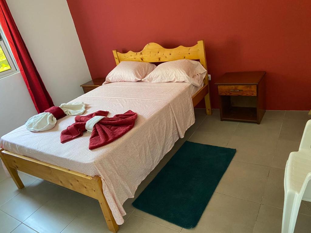 a bedroom with a large bed with red walls at Casa Ze & sonia in Portela