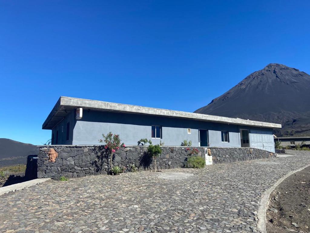 a house on a hill with a mountain in the background at Casa Ze & sonia in Portela