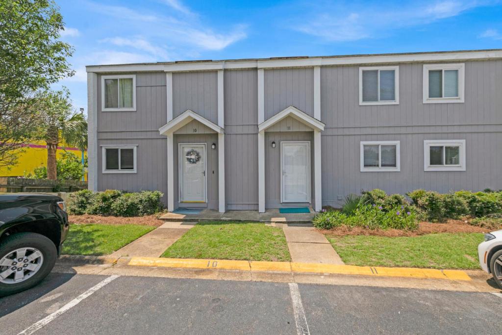 a gray house with a car parked in front of it at Southbay by the Gulf 11 a 4 Bedroom Townhome with Beach Access and 300ft of Private Beach in Destin