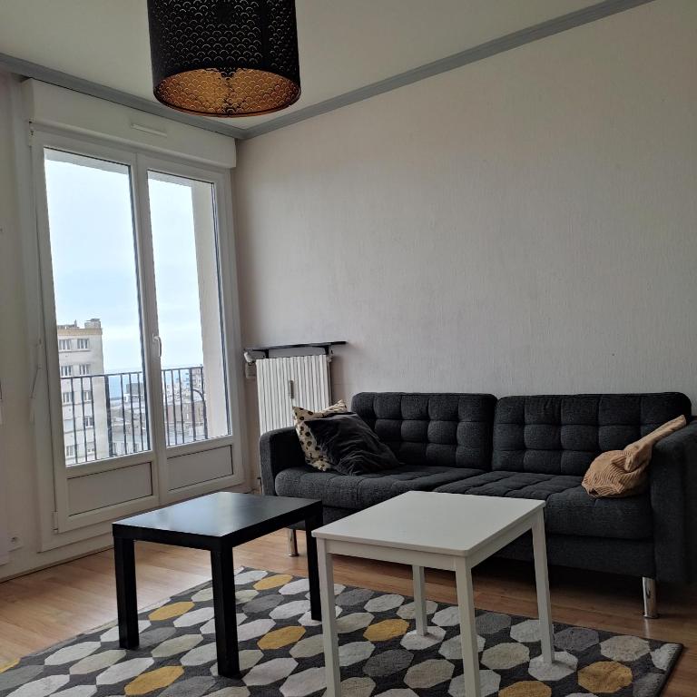 un salon avec un canapé et une table dans l'établissement Appt 2 ch vue mer à 5' de la gare de BREST, à Brest