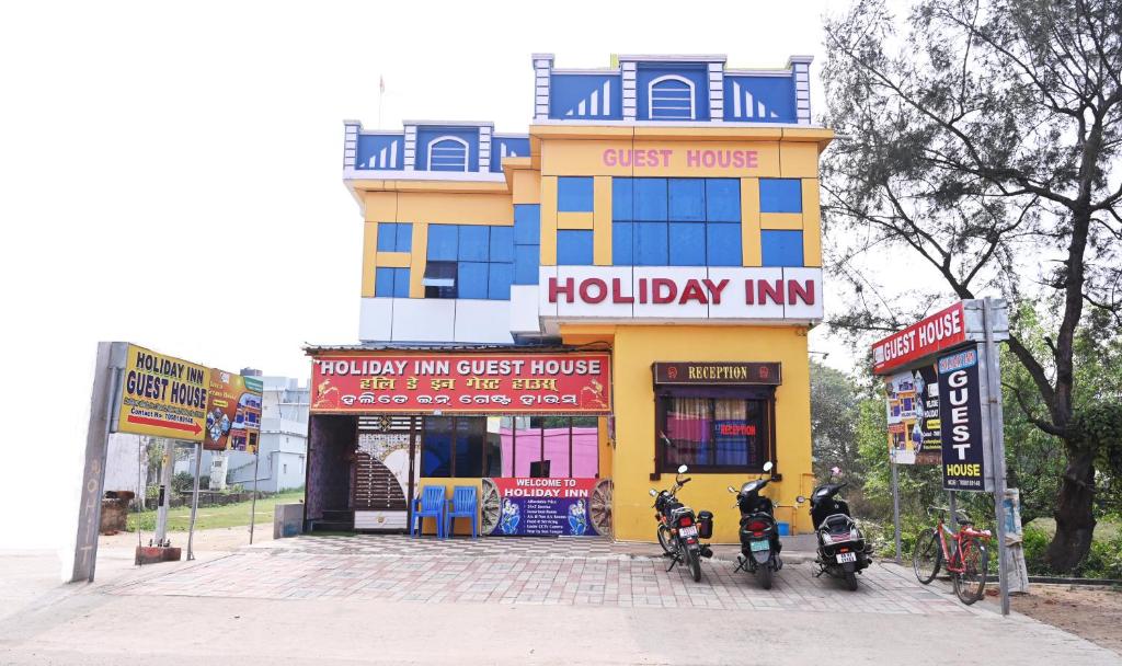 a building with two motorcycles parked in front of it at HOLIDAY INN in Konārka