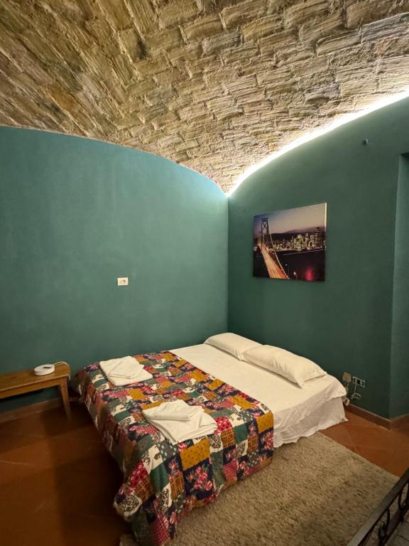 a bedroom with a bed in a blue wall at Scipioni Vatican Suite in Rome