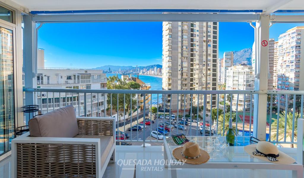 a balcony with a view of a city at La Perla Benidorm Apartment seaview & pool Levante Beach in Benidorm