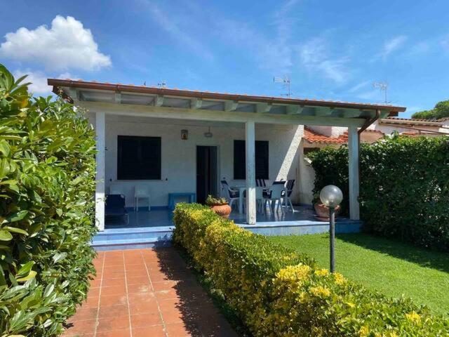 a house with a pavilion in front of a yard at Villa Azzurra in San Felice Circeo