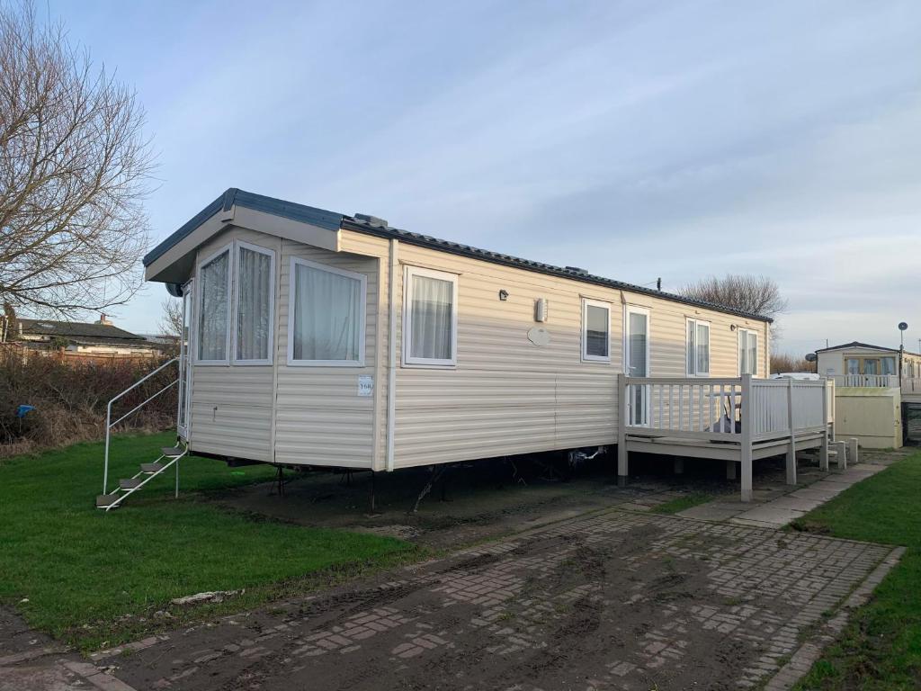 a mobile home is parked in a yard at Garden View Retreat in Ulrome