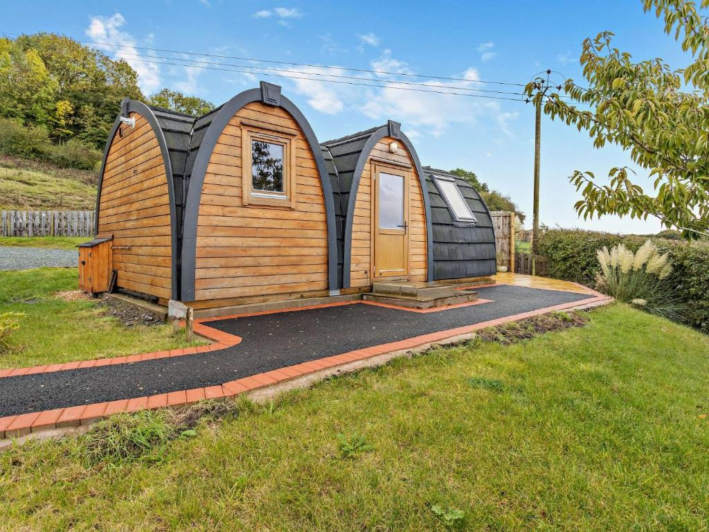 a tiny house with a pitched roof in a yard at 1 Bed in Sheinton 93394 in Leighton
