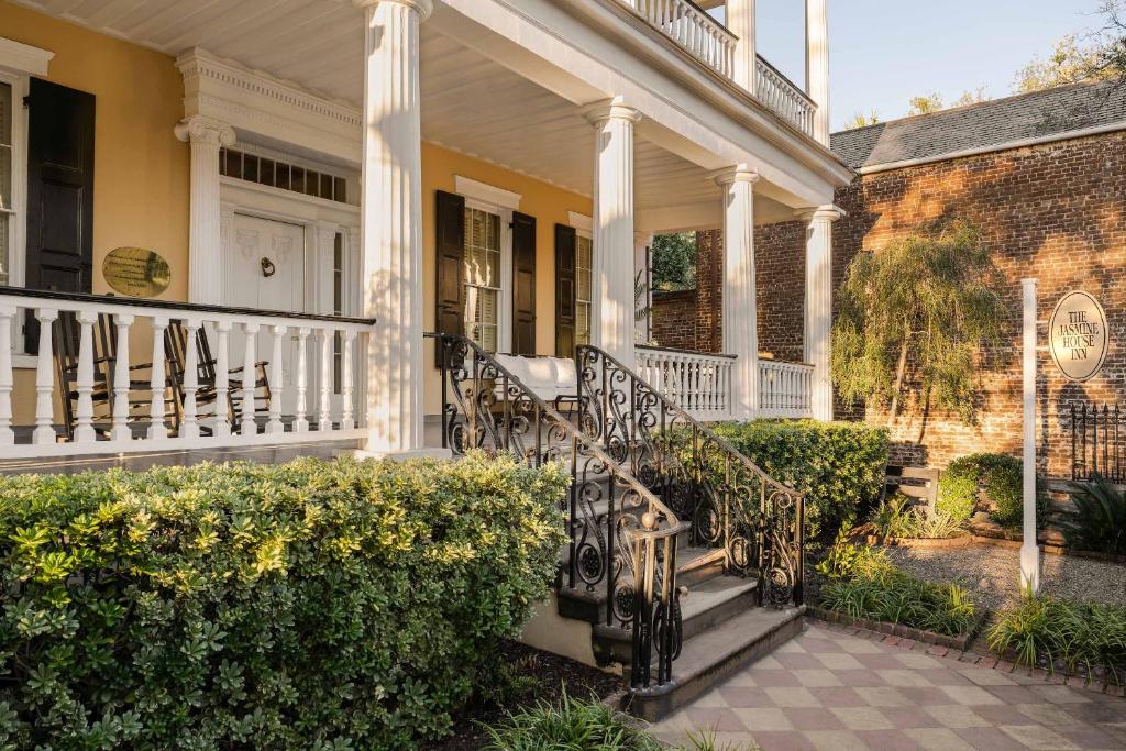 a white house with a porch and a staircase at The Jasmine House in Charleston