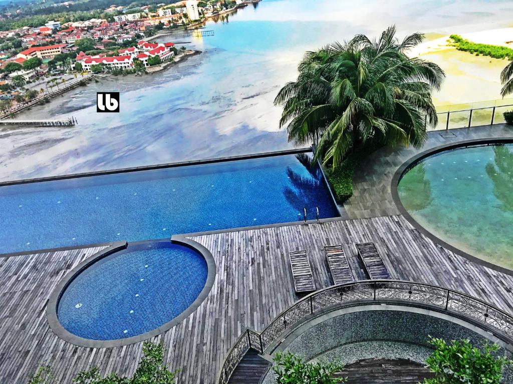 an aerial view of a beach and a swimming pool at Silverscape Residence Melaka in Melaka