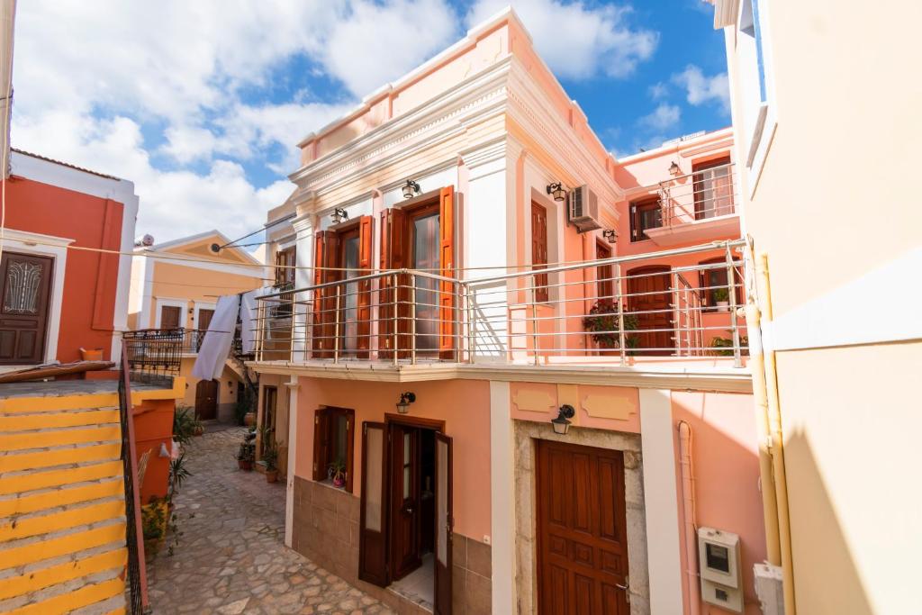 a street view of a building with pink at YIAYIA's Central Apartment in Symi