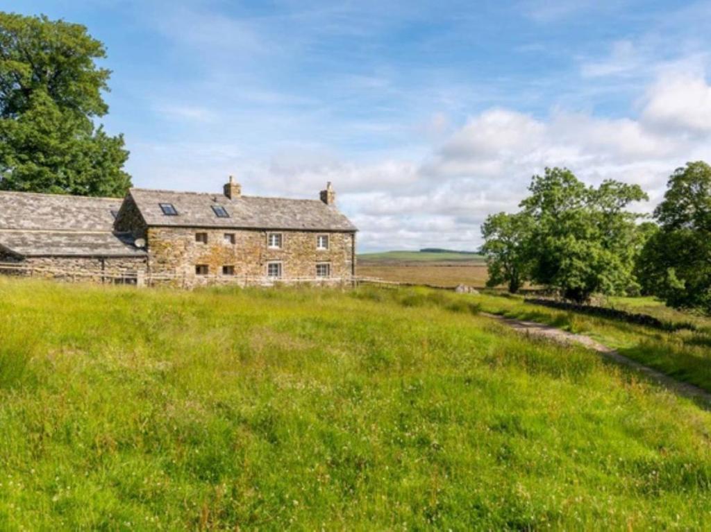 an old stone house in a field of grass at 3 Bed in Askham 93429 in Askham